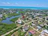 Elevated drone view showing the home's proximity to waterways and the Gulf Coast.
