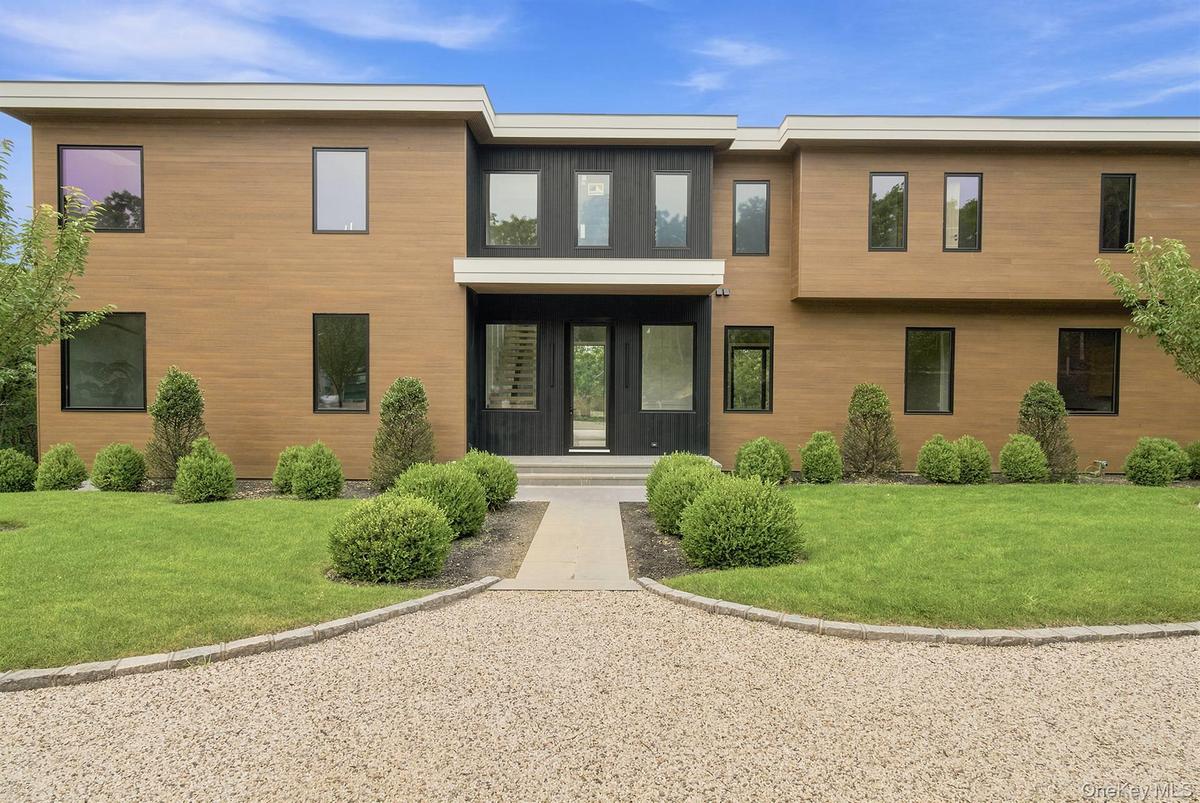 Modern architectural exterior featuring wood-finish siding and dark trim accents