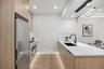 Kitchen featuring stainless steel appliances, modern cabinets, light brown cabinets, a sink, and recessed lighting