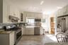 New kitchen layout with timeless finishes makes this a bright kitchen that catches the afternoon light over the kitchen sink.