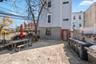 Rear view of property featuring a patio and brick siding