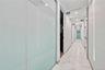 Hall featuring light marble finish flooring and recessed lighting
