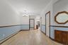 Spare room featuring a baseboard heating unit, a chandelier, and light wood-style floors
