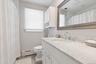Full bathroom with vanity, a shower with curtain, and a baseboard radiator