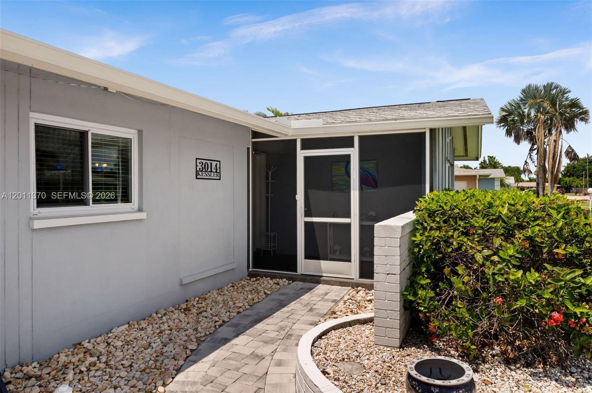 Welcoming entry with large screen porch in front