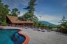 View of pool with a deck with mountain view and a fenced in pool
