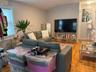Living area featuring lofted ceiling and wood finished floors