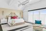 Bedroom featuring lofted ceiling, baseboards, wood finished floors, and ceiling fan