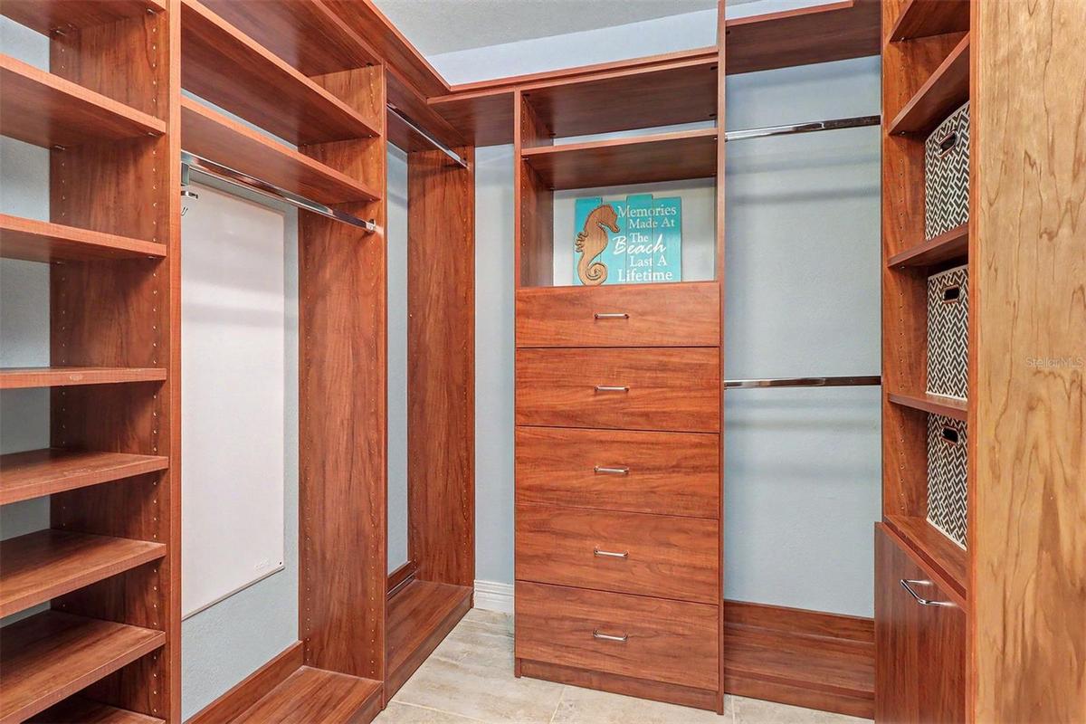 Custom-designed closet systems in all rooms maximize organization throughout the residence. The Primary Suite's walk-in closet offers premium built-in