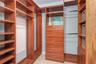 Custom-designed closet systems in all rooms maximize organization throughout the residence. The Primary Suite's walk-in closet offers premium built-in