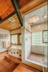 Primary bathroom featuring a healthy amount of sunlight, a shower and bath