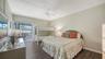 Primary bedroom features floor to ceiling sliders opening into the lanai.