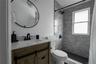 Full bath with vanity and a shower stall