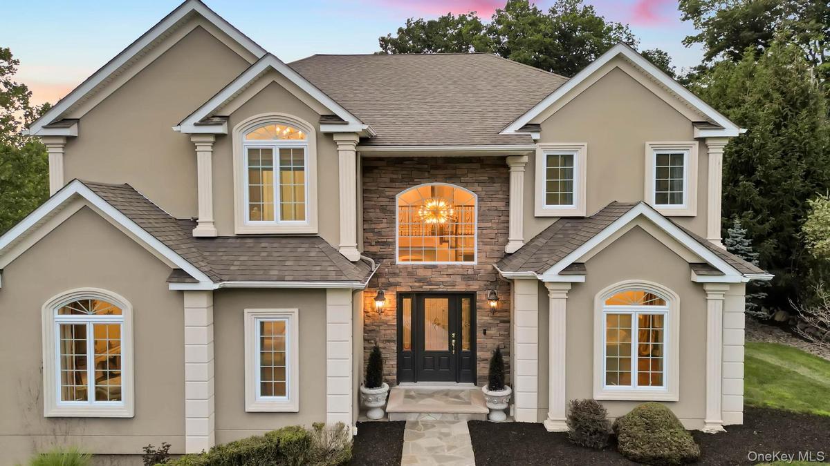 Beautiful detailing as seen with multiple angles cutouts oversized windows and lovely entry