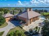 Completing the property are two separate two-car garages, including a beautifully finished main garage with tiled flooring and cherry wood walls and c