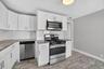 Unit #2-Kitchen featuring granite countertops and stainless-steel appliances.