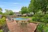 View of swimming pool featuring an exterior structure, a fenced backyard, an outbuilding, and a patio