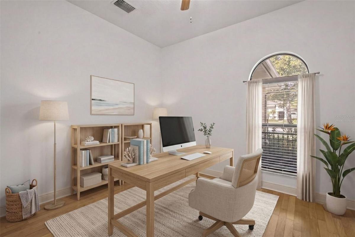 A dedicated office or den provides flexible space for working from home, studying, or relaxing. - virtually staged