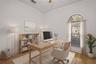 A dedicated office or den provides flexible space for working from home, studying, or relaxing. - virtually staged