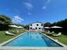 Outdoor pool with a lawn and a patio