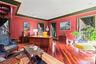 Room featuring rich red walls and dark green crown molding