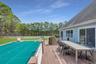 Deck featuring outdoor dining space, a lawn, and fence