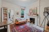 Sitting room featuring a textured ceiling, hardwood / wood-style flooring, and a fireplace with flush hearth