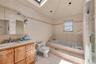 Luxurious primary bathroom on the 2nd floor, full size jacuzzi bathtub and a shower bathroom, skylight in the soaring ceiling for nature sunlight