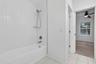 Guest Bathroom Shower tub combination water closet seperate with door and access to one of the bedrooms