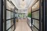 The architectural presence of the home is immediately evident as you enter the foyer through breathtaking 10-foot glass and iron entry doors.