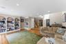 Living area featuring wood-finish flooring, recessed lighting, and integrated ceiling speakers