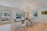 Dining area featuring wainscoting, light wood-style floors, crown molding, and recessed lighting