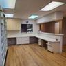 Kitchen with built in desk, light countertops, a peninsula, and light wood finished floors