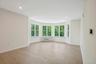 Dining area leads to living room with turreted bay window alcove