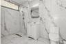 Bathroom featuring a marble finish shower, vanity, and marble tiled flooring