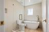 Bathroom with tile walls, wood finished floors, a soaking tub, a shower stall, and recessed lighting