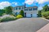 Extra-wide driveway with attached oversized 2 car garage.