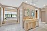 The primary bathroom offers dual walk-in closets, a soaking tub, and a separate shower.