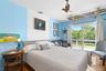 Bedroom with wood finished floors and ceiling fan