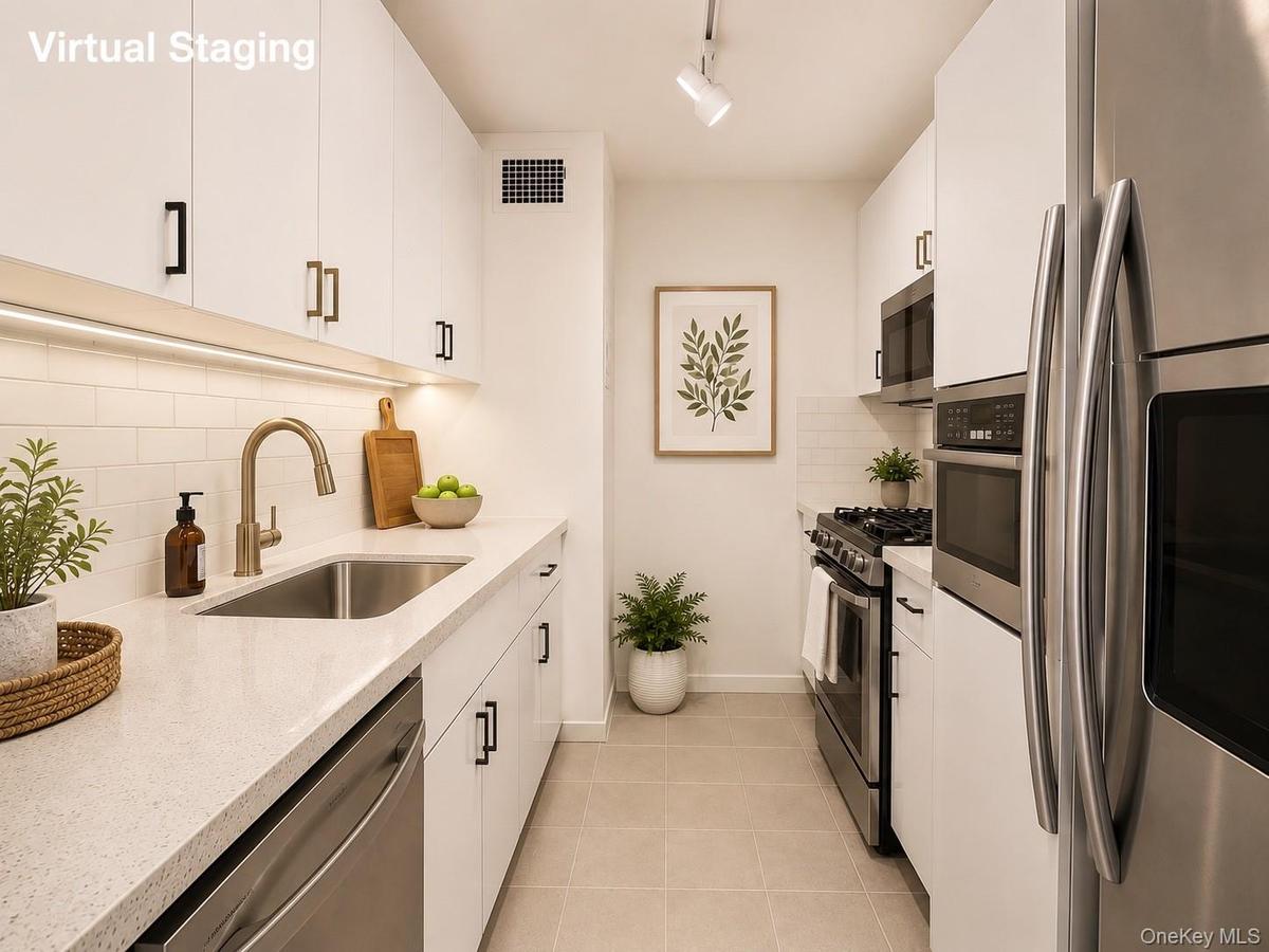 Sleek, modern galley kitchen featuring abundant cabinetry, generous countertop space, stainless steel appliances, and a clean, efficient layout. Ample