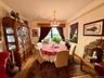 Open to the living room, double panel window, hardwood floors