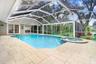 Amazing views of backyard and step-down patio area overlooking the backyard and lake.