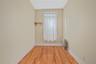 Empty room with light wood-type flooring and radiator