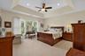 Primary bedroom: Spacious primary suite with tray ceiling and abundant natural light