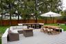 Wooden terrace featuring outdoor dining space, an outdoor hangout area, and a fenced backyard