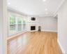 Spacious Living Room area featuring polished wood flooring, recessed lighting and a Fireplace