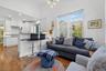 Living area with a chandelier, dark wood-style floors, recessed lighting, and lofted ceiling