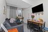 Ground Floor compact living area featuring neutral wall paint, a window with security bars, and grey tile flooring