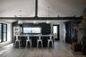Kitchen featuring a kitchen breakfast bar, dark cabinetry, hanging light fixtures, lofted ceiling, and light wood-type flooring