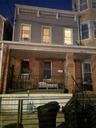 View of front facade featuring a porch and brick siding